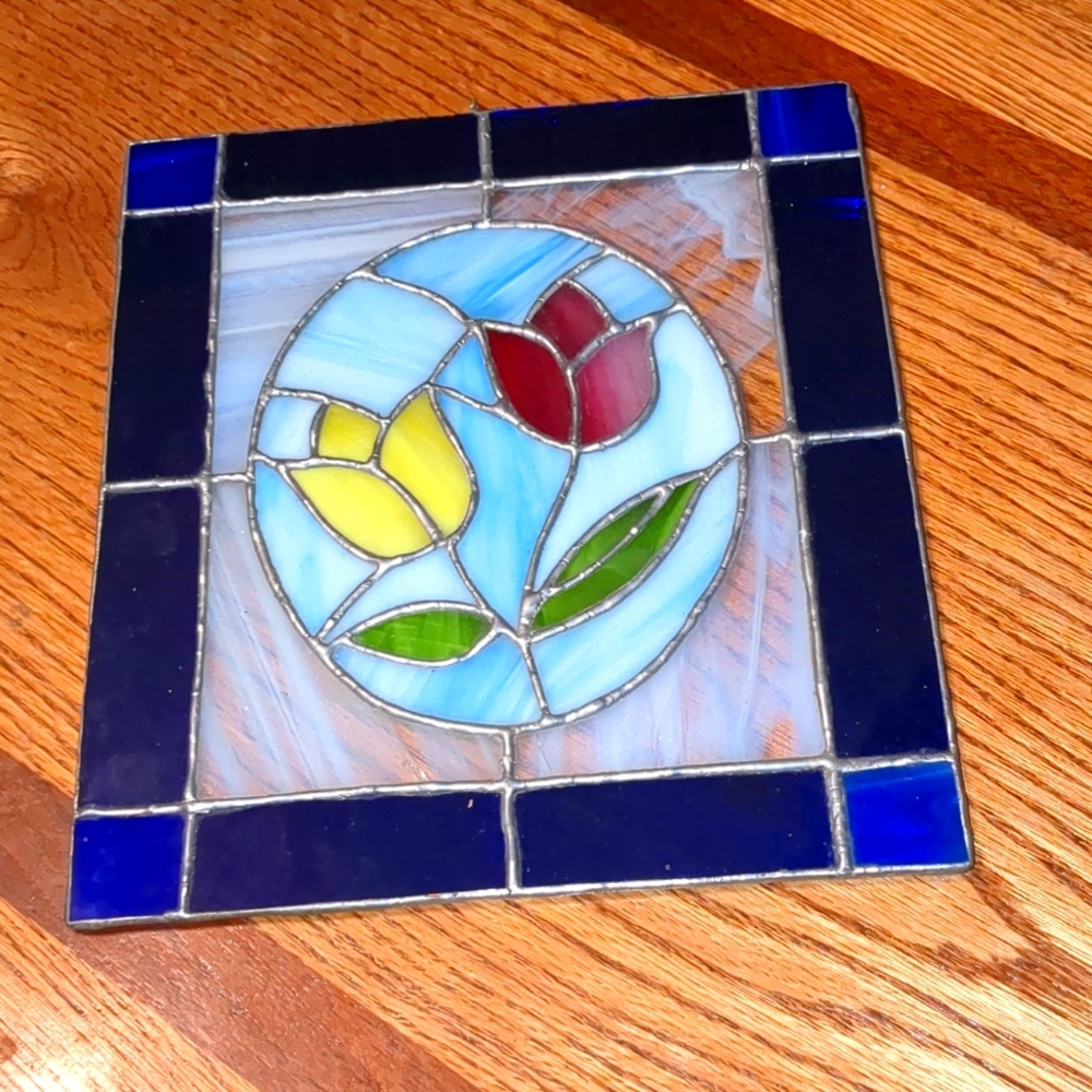 Beautiful piece of stained glass, two tulips in a beautiful blue cobalt frame.